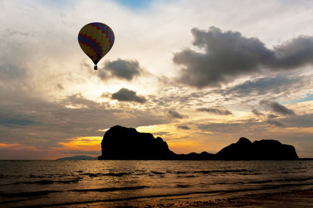 Balloon above black mountain in Thailandの写真素材