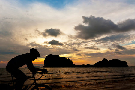 Cycling at beach on twilight timeの写真素材