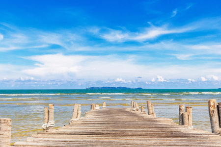 Wooden jetty at beach with blue sky on summerの写真素材