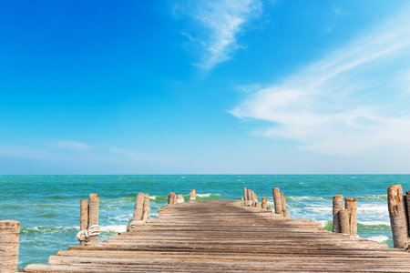 Wooden jetty and clean sea with blue sky on daylightの写真素材