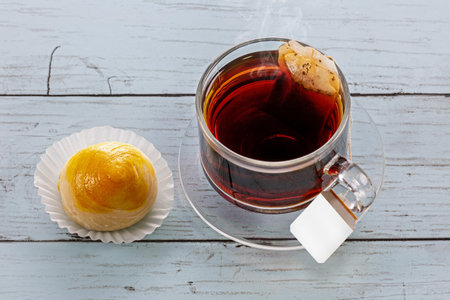 Tea cup with snack on wooden tableの写真素材