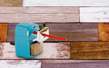 Pencile sharpenter isolate on wooden table backgroundの写真素材