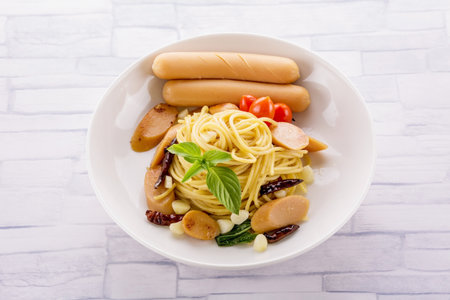 Spaghetti with sausage spicy on wooden tableの写真素材