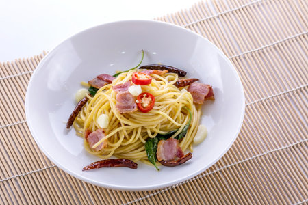 Spaghetti with beacon spicy on wooden tableの写真素材