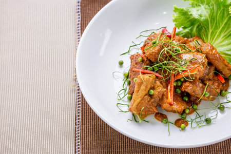 Stir fried pork spicy on wooden tableの写真素材