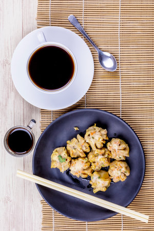 Dumpling with black coffee on wodden tableの写真素材