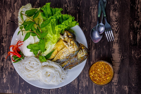 Fried mackerel with Thai rice noodles and many vegetableの写真素材