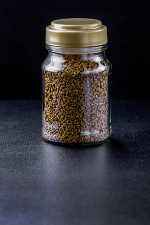 Glass bottle instant coffee on black backgroundの写真素材