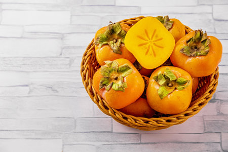 Persimmon fresh fruit from Asia on bright tableの写真素材