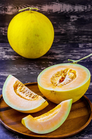 Cantaloupe fresh fruit from Thailand Asia on dark wooden tableの写真素材