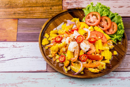 Corn salad with shrimp teasy Thai street food on wooden backgroundの写真素材