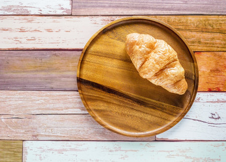 Croissant good and tasty bakery on circle wooden plateの写真素材