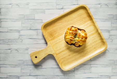 Bakery with sausage on wooden plate