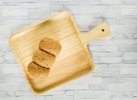 Bread breakfast on wooden plateの写真素材