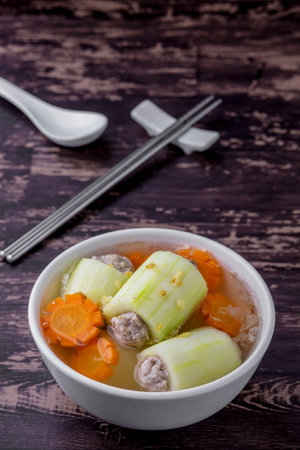 Stuffed cucumber soup tasty Thai food on dark wooden tableの写真素材