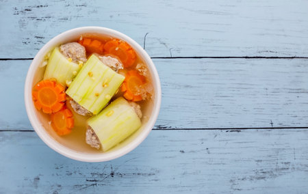 Stuffed cucumber soup tasty Thai food on blue wooden tableの写真素材