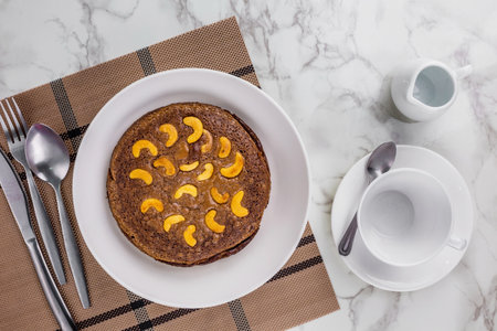 Brownie cake with nuts on circle plate marble tableの写真素材