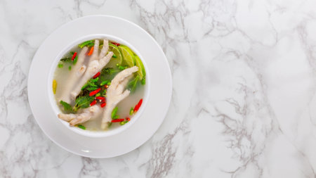 Chicken feet spicy soup tasty Thai food on marble tableの写真素材