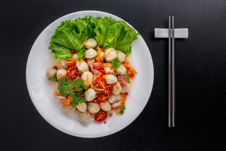 Pork ball spicy salad Thai food on black tableの写真素材
