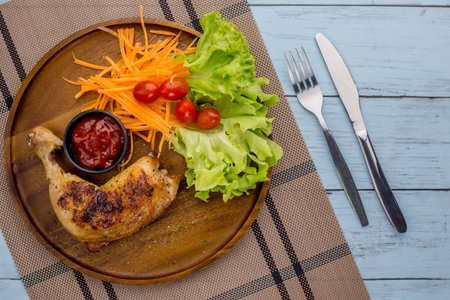 Chicken drumstick steak with black pepper on wooden tableの写真素材
