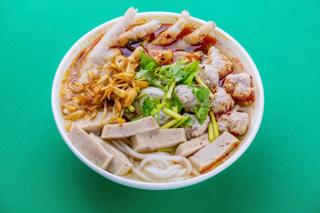 Vietnamese noodle soup with chicken feet Asian cuisine on green background