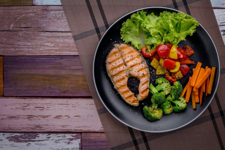Salmon steak favorite food on dark wooden backgroundの写真素材