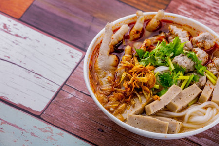 Vietnamese noodle soup with chicken feet Asian cuisine on wooden backgroundの写真素材