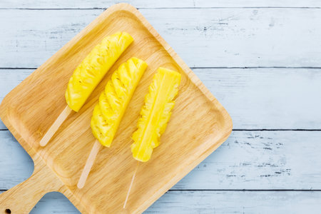 Pineapple fresh fruit on blue wooden backgroundの写真素材