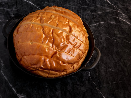 Bread bun circle shape on dark marble background