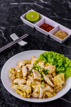 Fried noodles with roasted chicken Asia cuisine on dark marble backgroundの写真素材