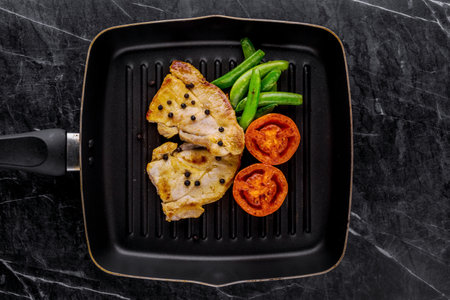 Pork steak favorite cuisine on dark marble backgroundの写真素材