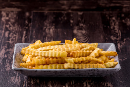 French fried favorite fast food on wooden background