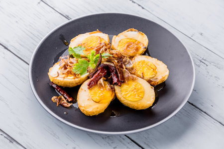 Egg with tamarind sauce on blue wooden backgroundの写真素材