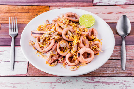 Fried squid with garlic on wooden backgroundの写真素材