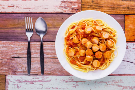 Spaghetti with sausage tomato sauce on dark wooden backgroundの写真素材