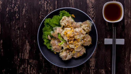 Boiled dumpling breakfast asia cuisine on dark wooden backgroundの写真素材