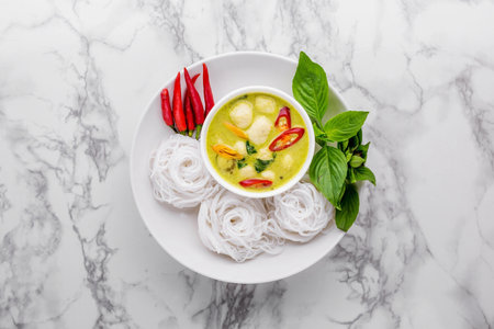 Rice noodles with green curry meatballs on marble backgroundの写真素材