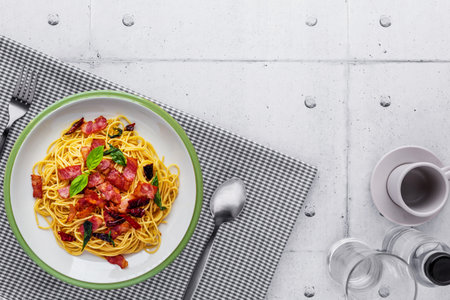 Spaghetti with bacon chili on steel table backgroundの写真素材