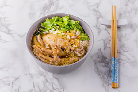 Noodles with braised chicken on marble table background