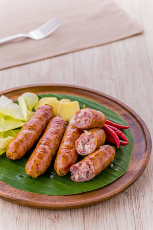 Thai sausage favorite street food on wooden table backgroundの写真素材