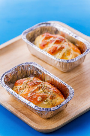 Mini pizza with sausage and cheese on blue backgroundの写真素材