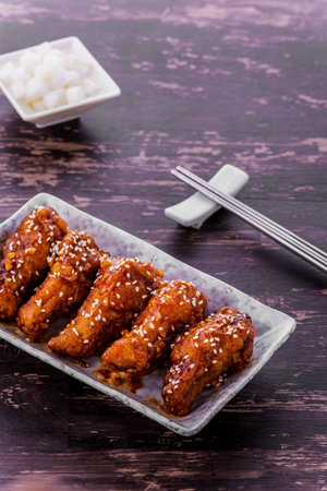 Korean fried chicken favorite food on dark wooden backgroundの写真素材