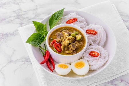 Rice noodles with green curry porkの写真素材