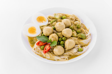 Rice noodles with green curry pork on white backgroundの写真素材