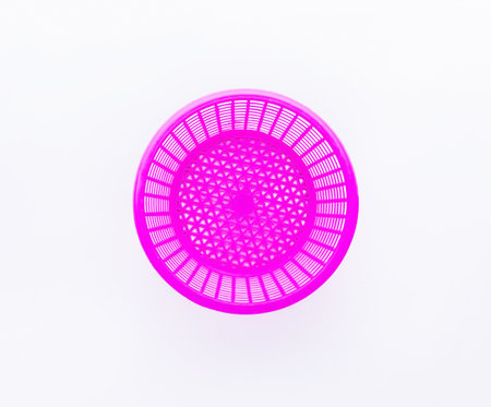 Pink plastic basket top view on white background