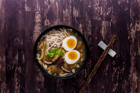 Fish maw in chicken broth on dark wodden table backgroundの写真素材