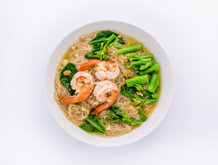 Rice noodles with seafood in thick gravy on white background