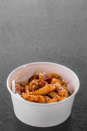 Fried Teokbokki Korea street food on dark table background
