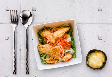 Fish nuggets with salad on steel table backgroundの写真素材