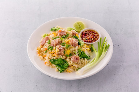Thai fried rice with sour pork on bright stone backgroundの写真素材
